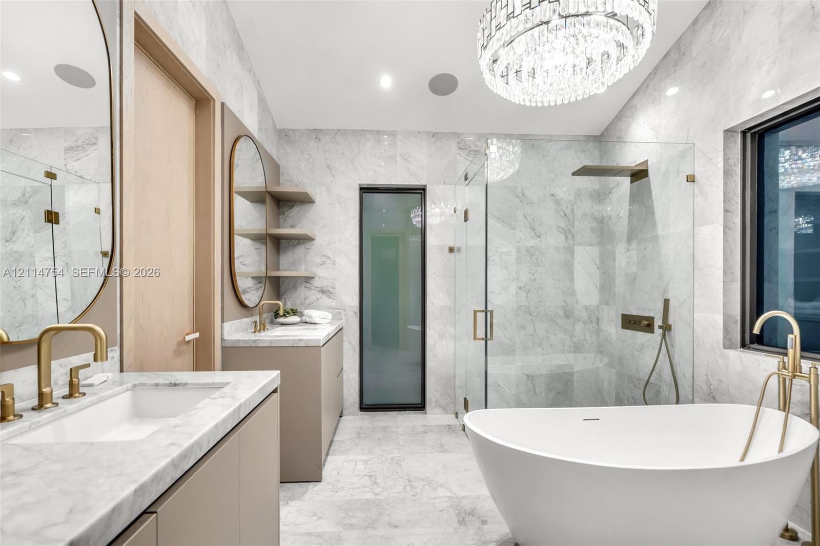 Custom walk-in closet featuring light wood-finish cabinetry, built-in drawer stacks with matte black pulls, vertical integrated LED accent lighting, full-length mirror with a black frame, and stone-finish flooring