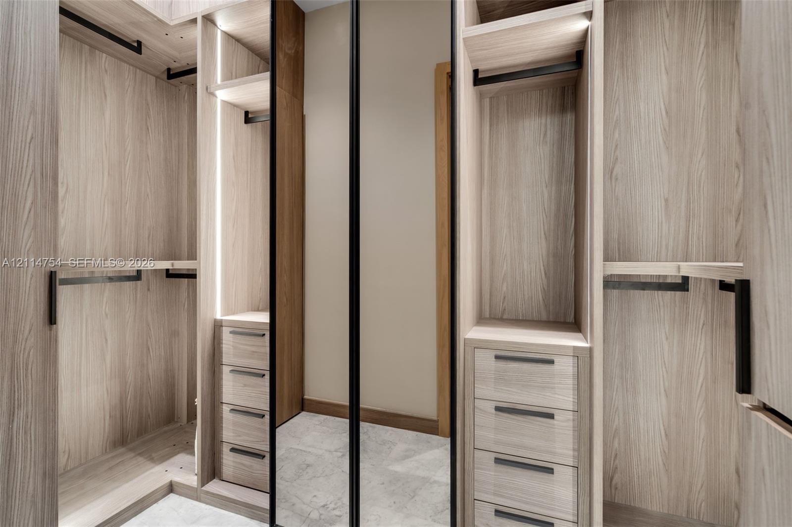 Hallway featuring high-gloss tile flooring, recessed ceiling lighting, linear ceiling diffusers, and wood-finish interior doors