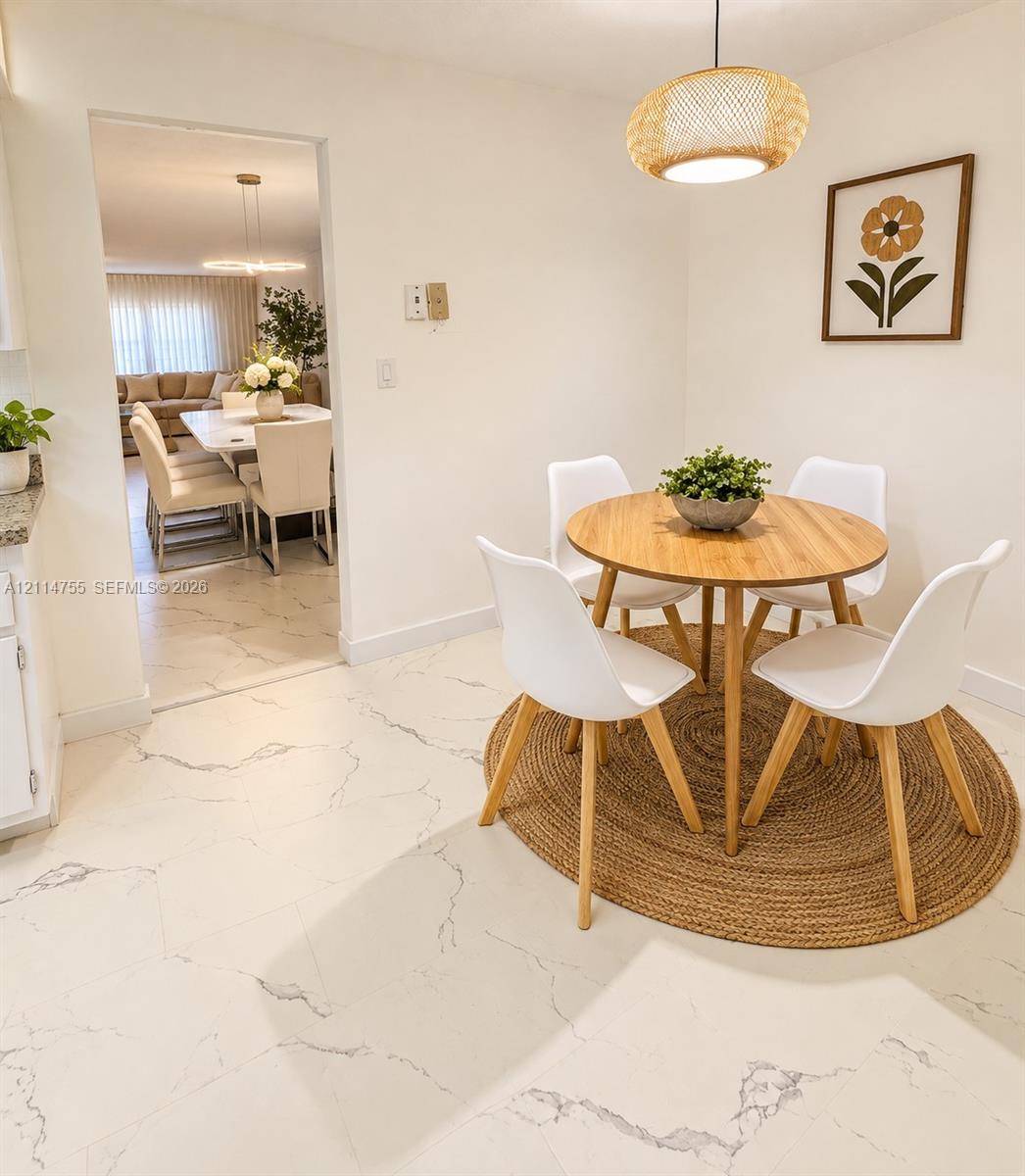 Large-format white stone-finish tile flooring with gray veining throughout, complemented by a woven pendant light fixture