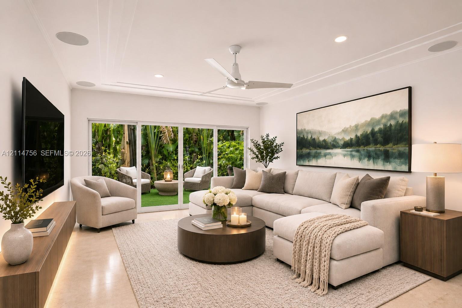 Living space featuring recessed lighting, a ceiling fan, crown molding, integrated ceiling speakers, and multi-panel sliding glass doors Living space featuring recessed lighting, a ceiling fan, crown molding, integrated ceiling speakers, and multi-panel sliding glass doors