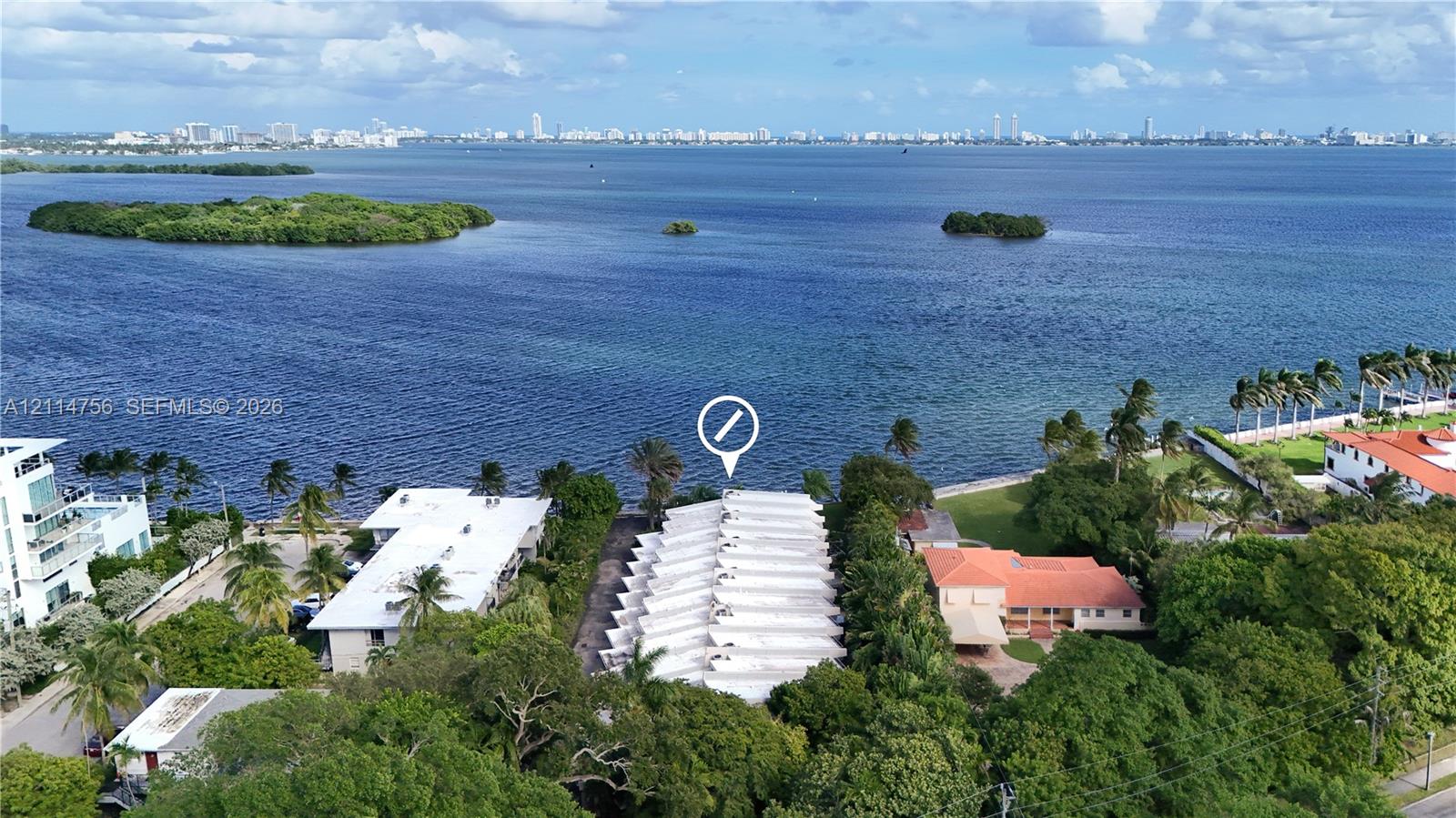 Waterfront property featuring extensive shoreline, mature landscaping, and proximity to expansive open water