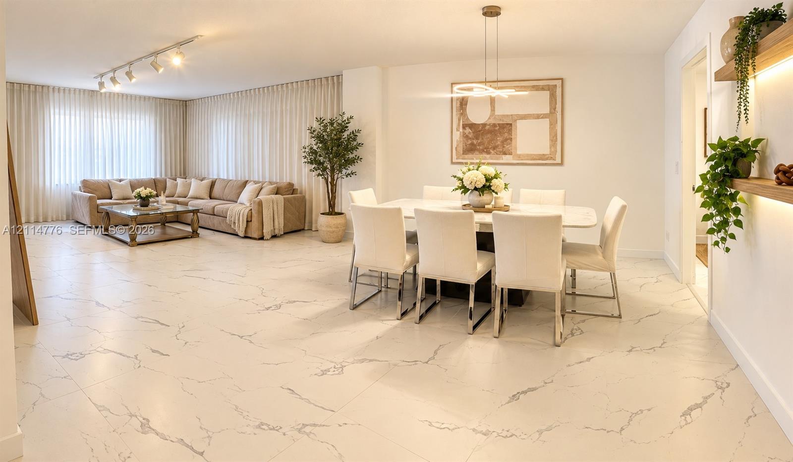 Large-format stone-finish tile flooring, recessed track lighting, modern pendant chandelier, and built-in wall shelving with integrated LED illumination