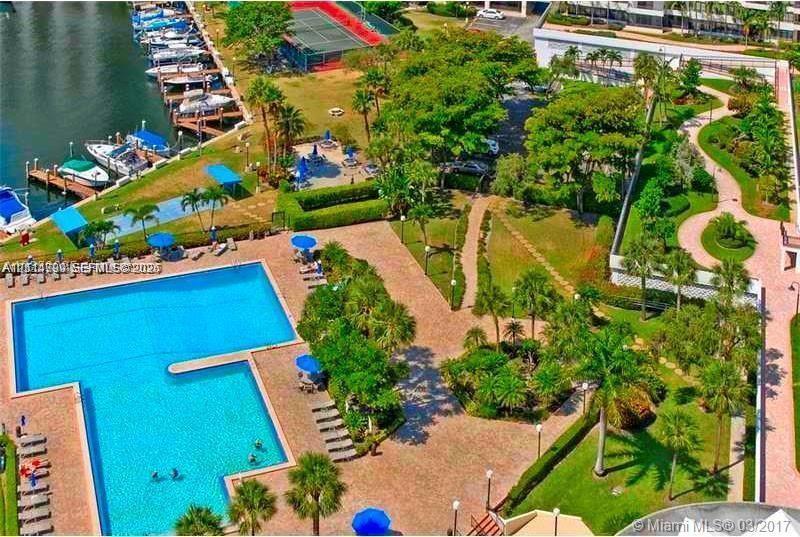Communal swimming pool, tennis court, boat slips, landscaped grounds, and paved walking paths