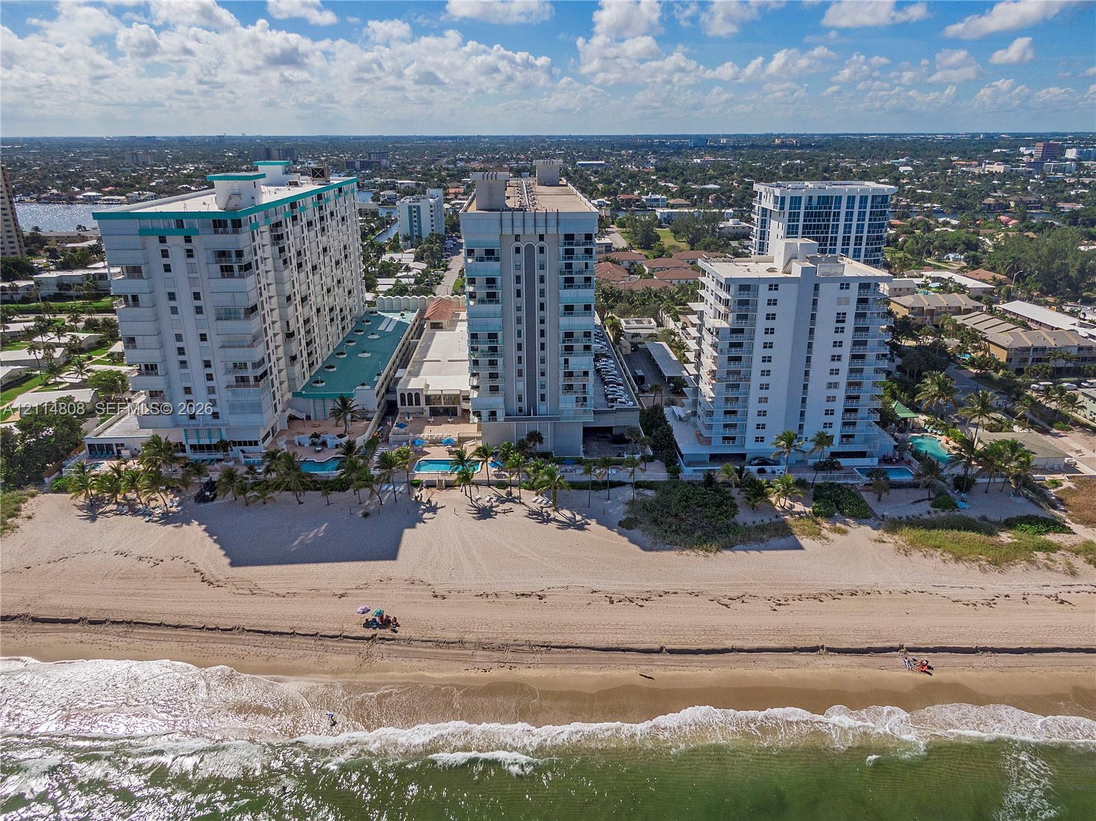 High-rise residential towers featuring direct oceanfront access, private beachfront, outdoor swimming pools, and palm-lined grounds High-rise residential towers featuring direct oceanfront access, private beachfront, outdoor swimming pools, and palm-lined grounds