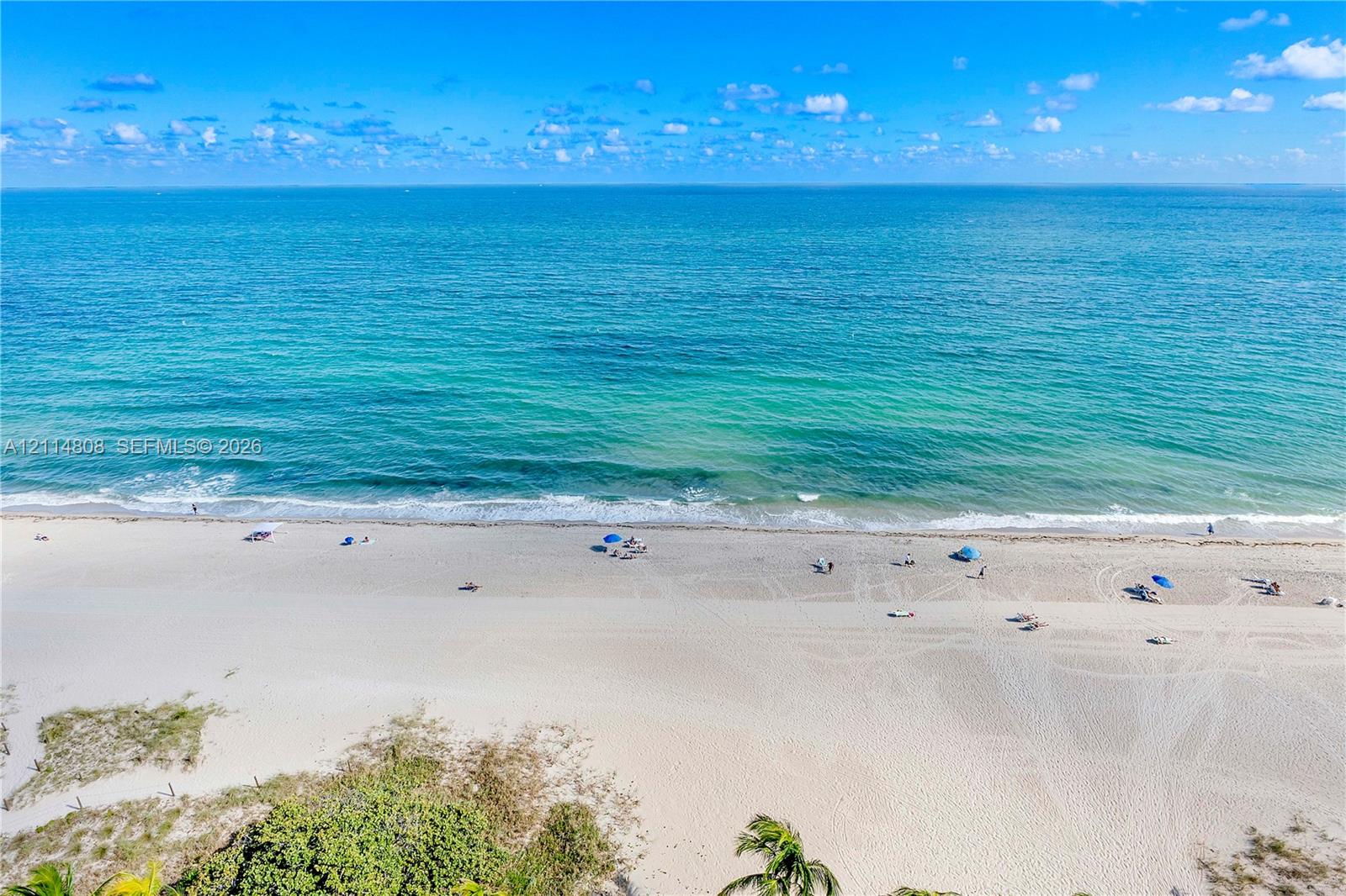 Oceanfront property featuring direct beach access, white sand coastline, and turquoise water