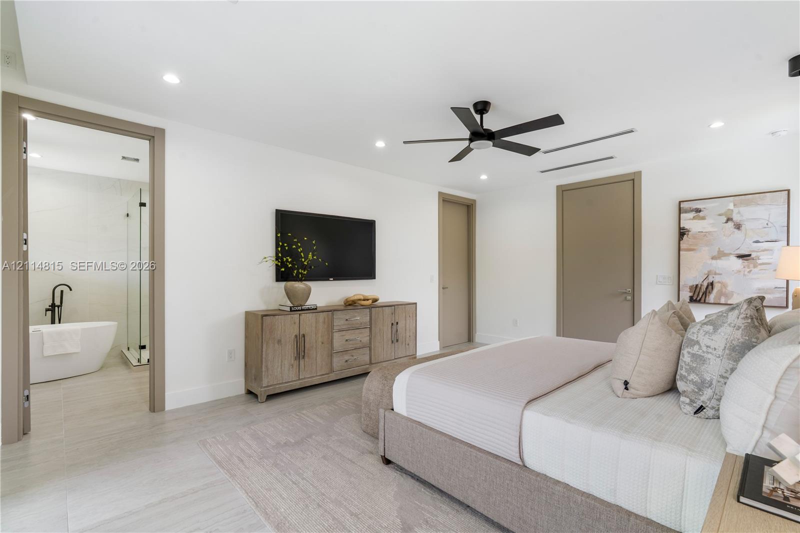 Neutral-toned room featuring a matte black ceiling fan, recessed lighting, and large-format tile flooring