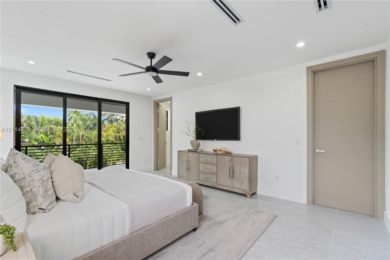 Recessed lighting, ceiling fan, tile flooring, and floor-to-ceiling sliding glass doors with black framing Recessed lighting, ceiling fan, tile flooring, and floor-to-ceiling sliding glass doors with black framing