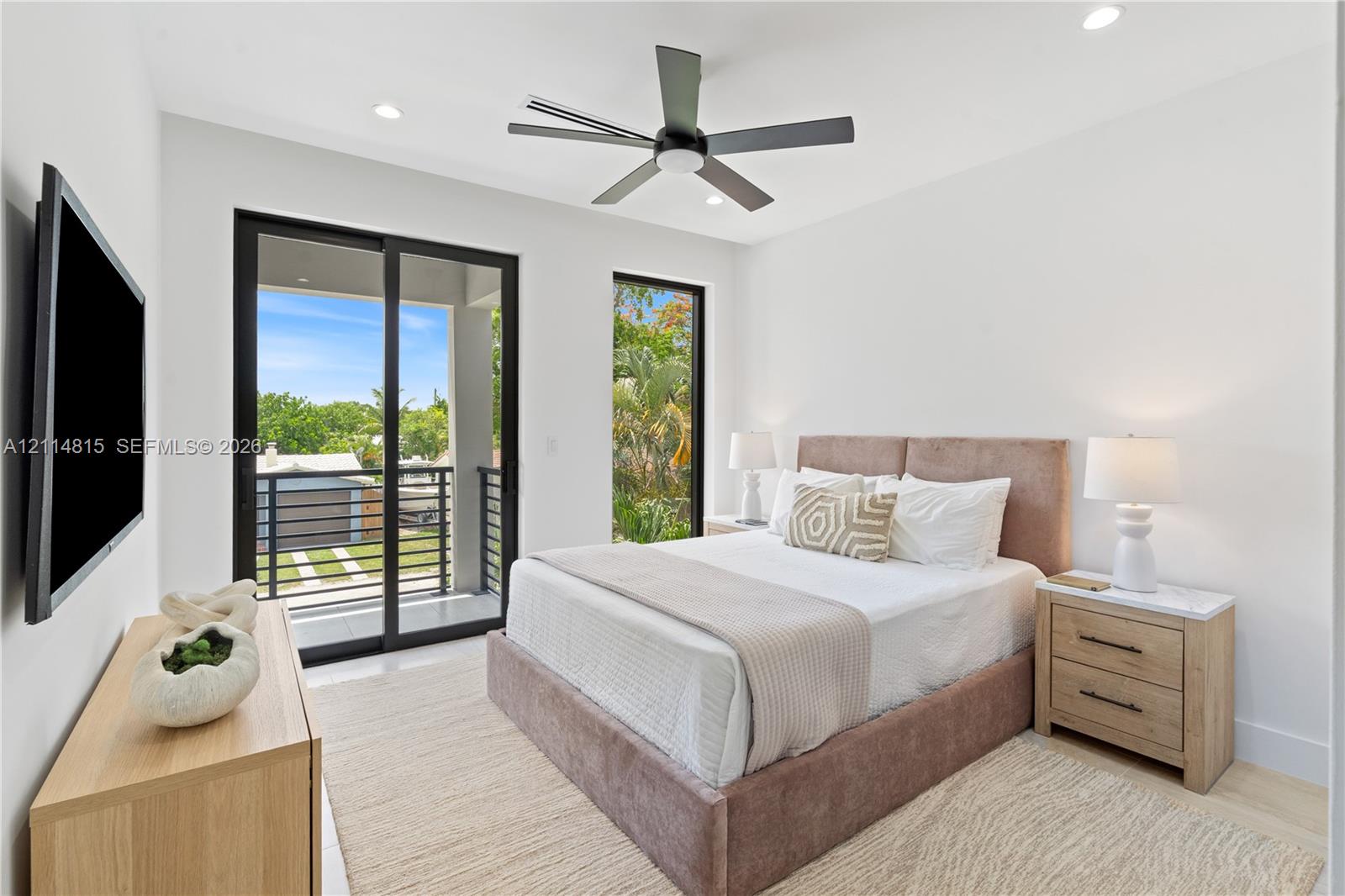 Bedroom featuring a matte black ceiling fan, recessed lighting, and expansive floor-to-ceiling windows