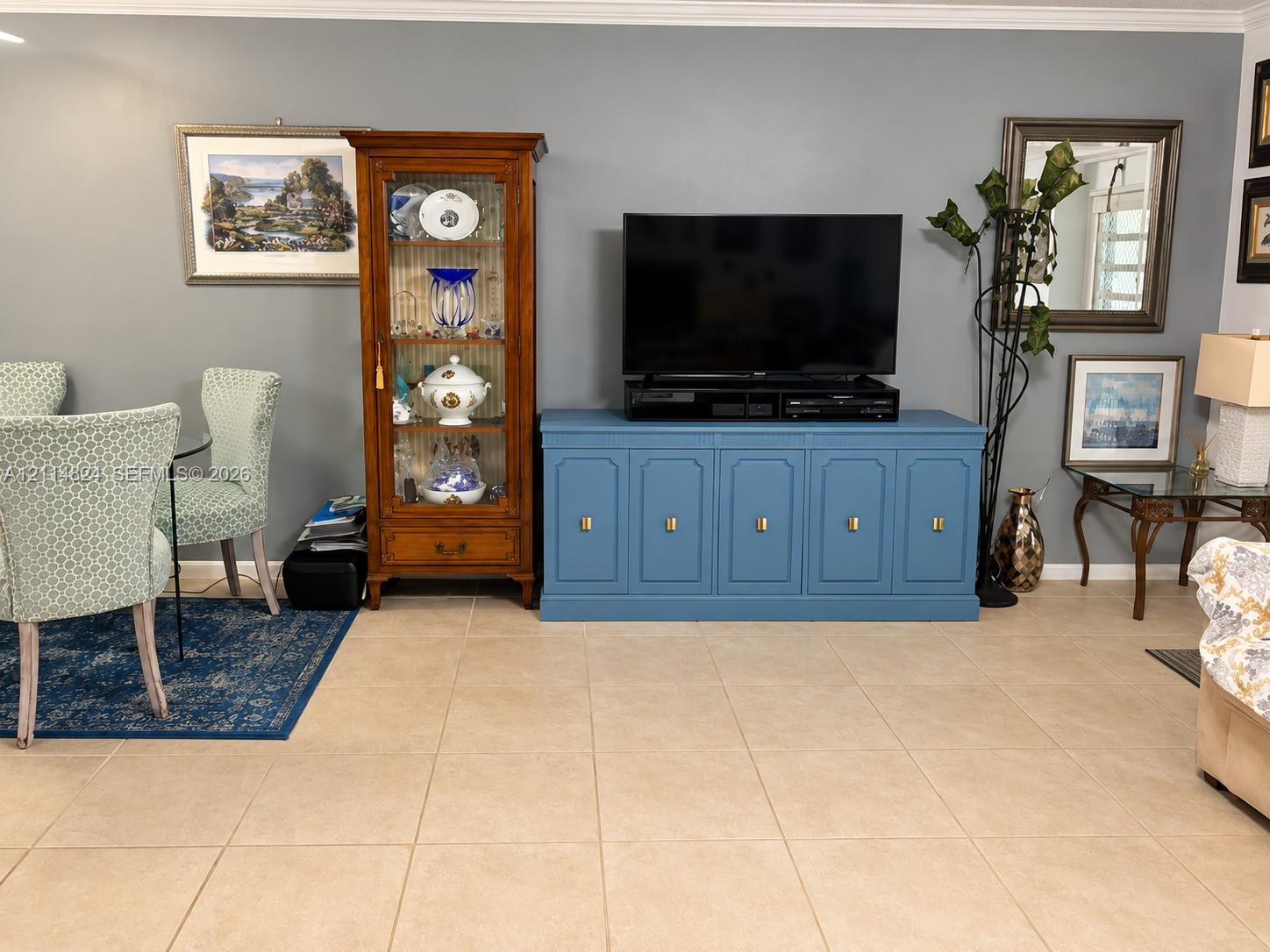 Living area featuring large-format ceramic tile flooring and neutral wall paint