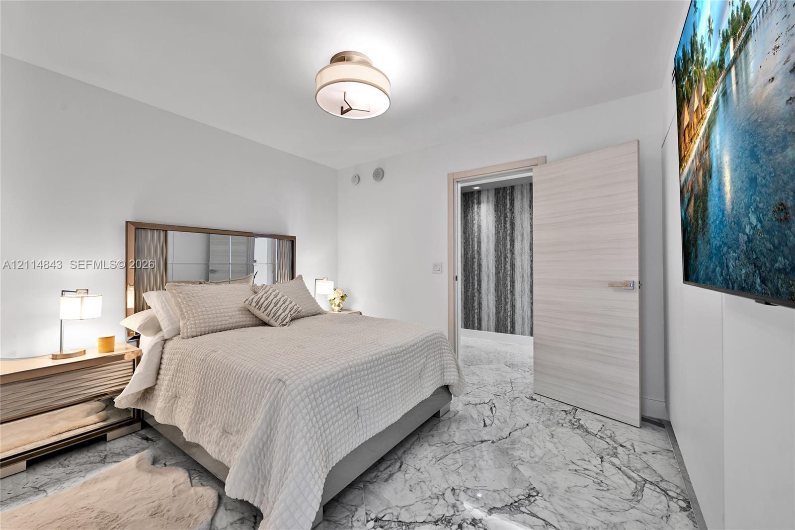 Stone-finish flooring, flush-mount lighting, and solid-core interior door with metallic hardware