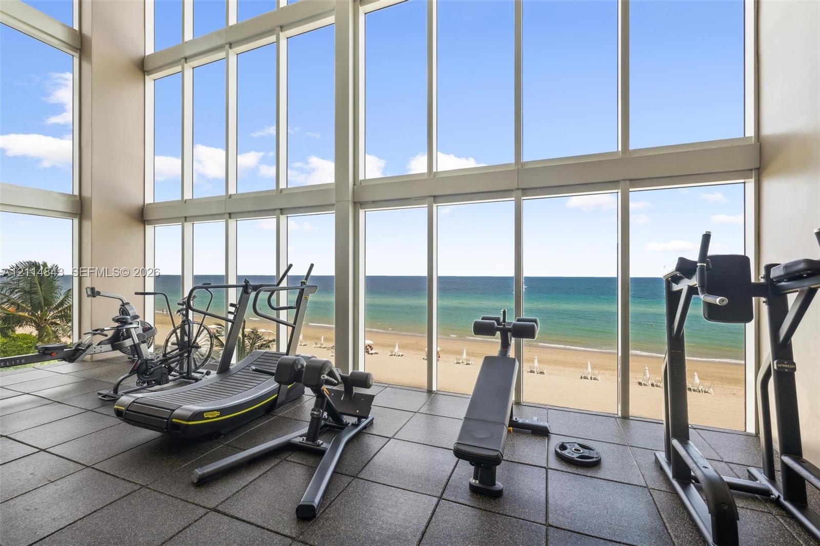 Floor-to-ceiling windows, double-height ceilings, and square-tile flooring