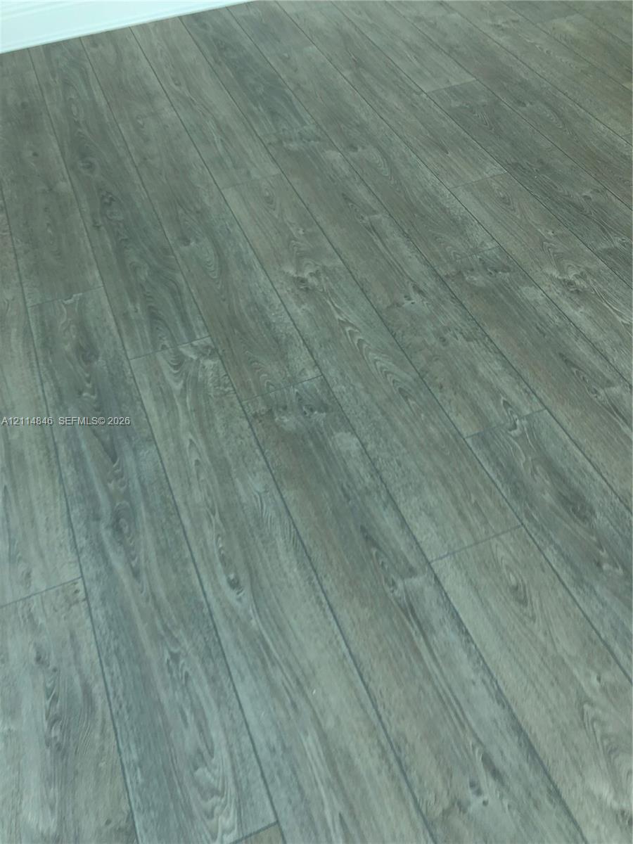 Wood-finish flooring featuring a neutral, cool-toned grain pattern