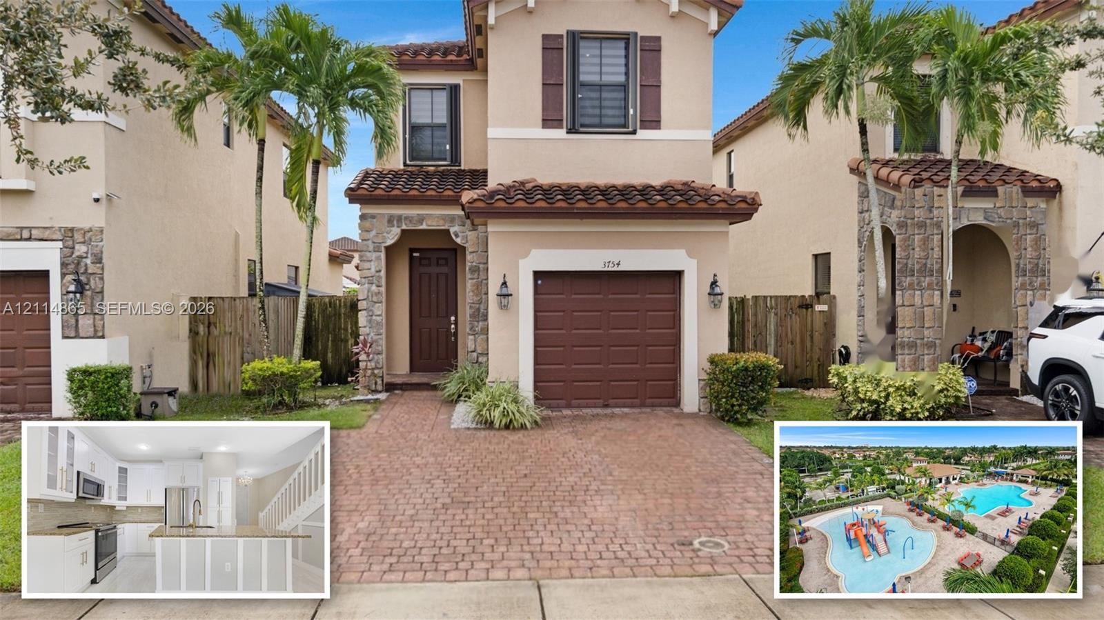 Stucco exterior featuring stone accents, a tile roof, a paved driveway, and an integrated garage