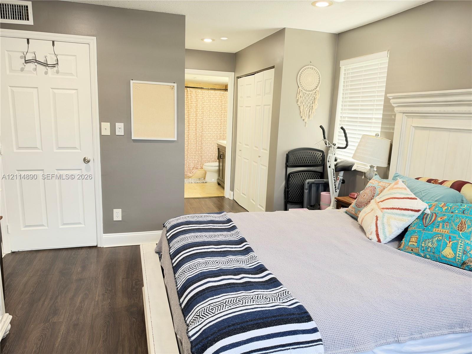 Wood-finish flooring, recessed lighting, and double-panel doors