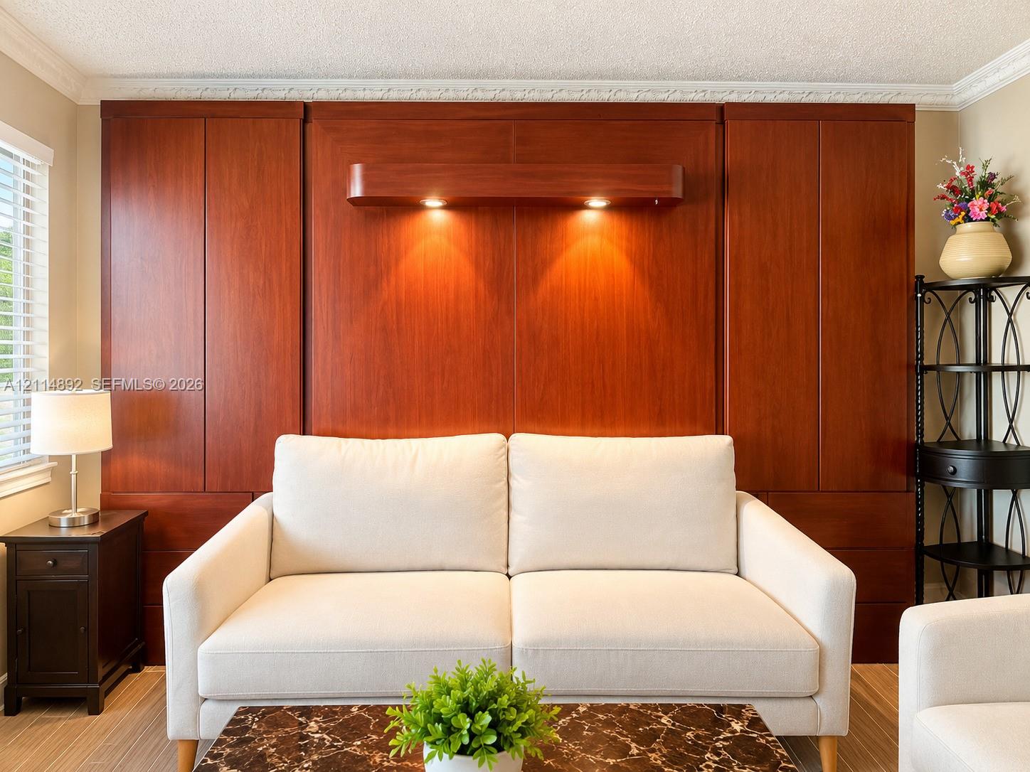 Custom floor-to-ceiling wood cabinetry, integrated wall-mounted task lighting, and crown molding detail