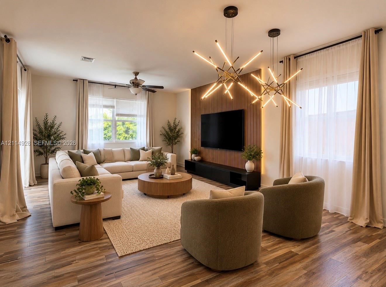 Living area featuring wood-finish flooring, dual starburst pendant light fixtures, and a vertical wood slat accent wall with integrated linear lighting