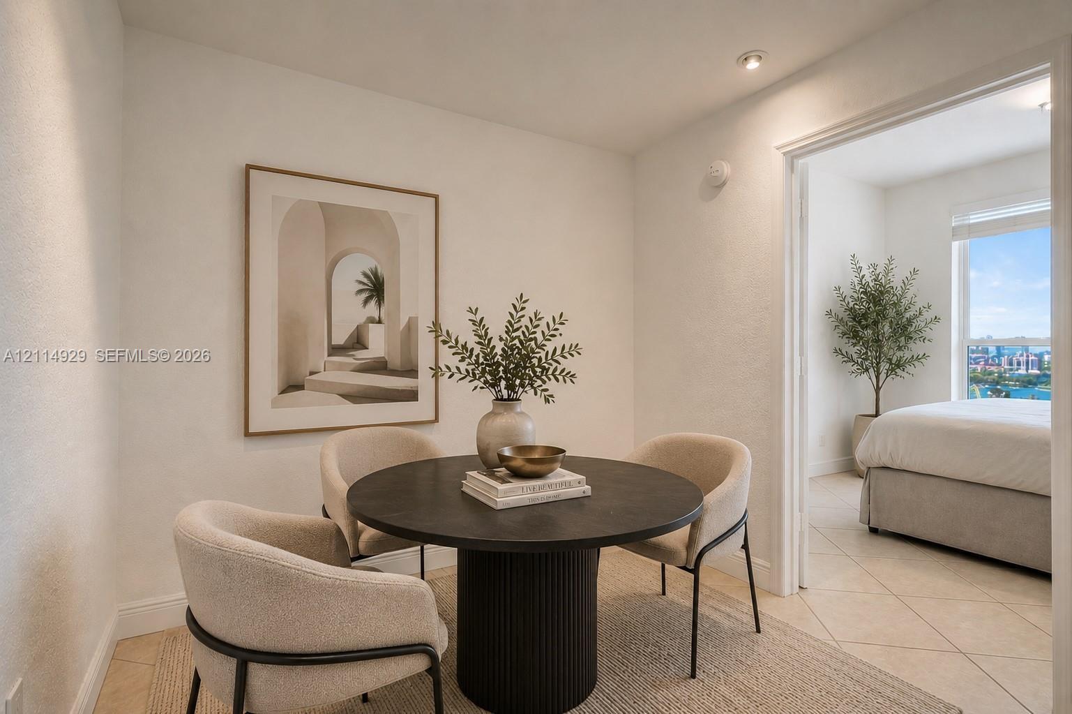 Neutral-toned interior space featuring recessed ceiling lighting, light-colored tile flooring, and a large window