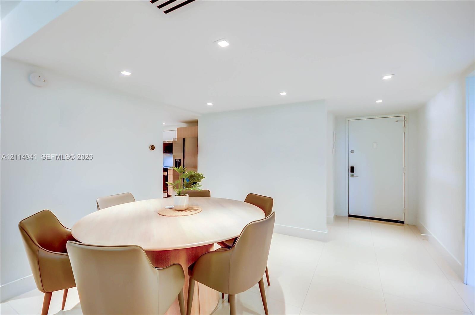 Recessed lighting, smooth finished ceiling, and light-toned tile flooring Recessed lighting, smooth finished ceiling, and light-toned tile flooring