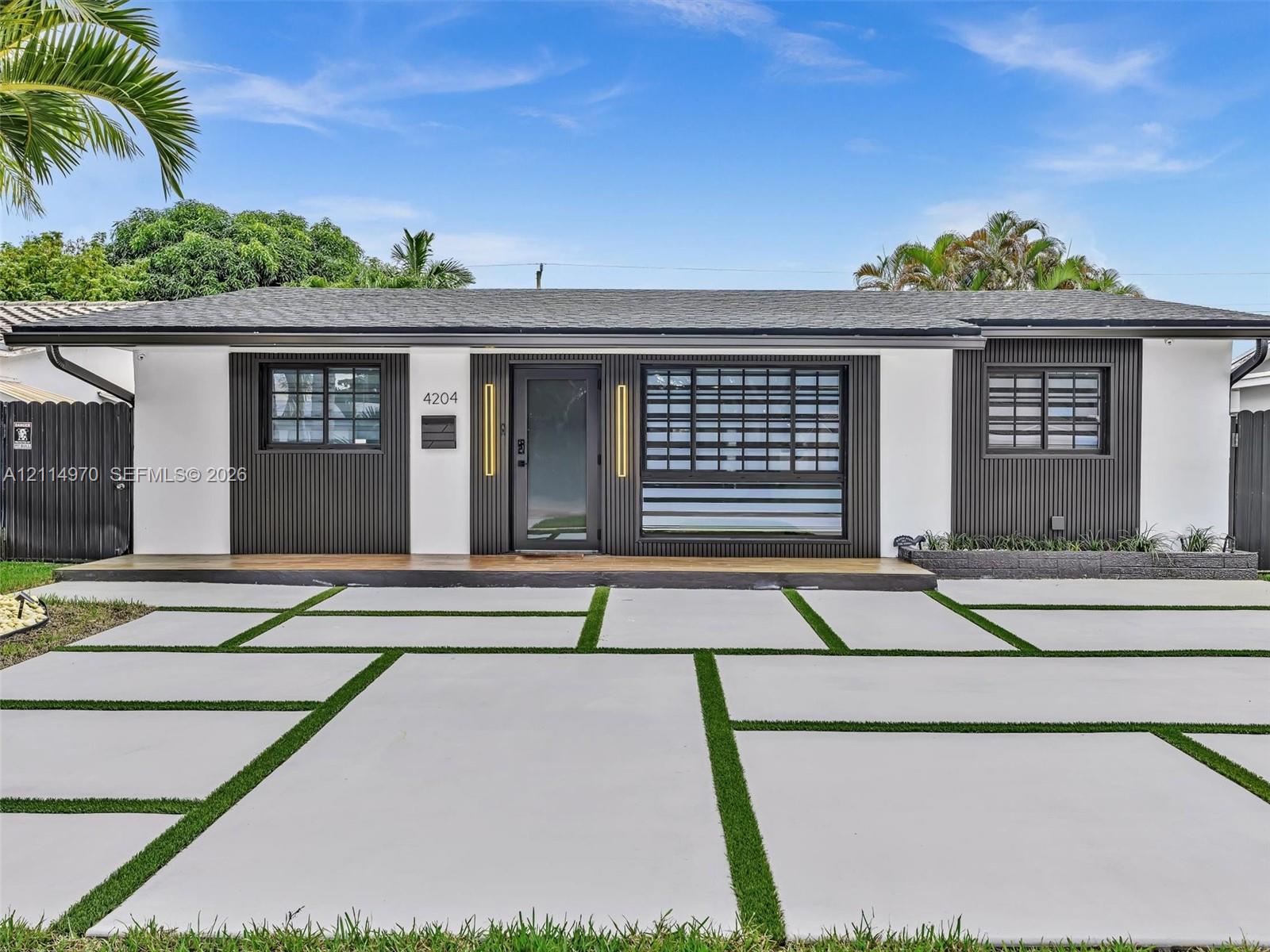 Single-story exterior featuring a high-contrast facade with vertical wood-slat siding and a covered front landing