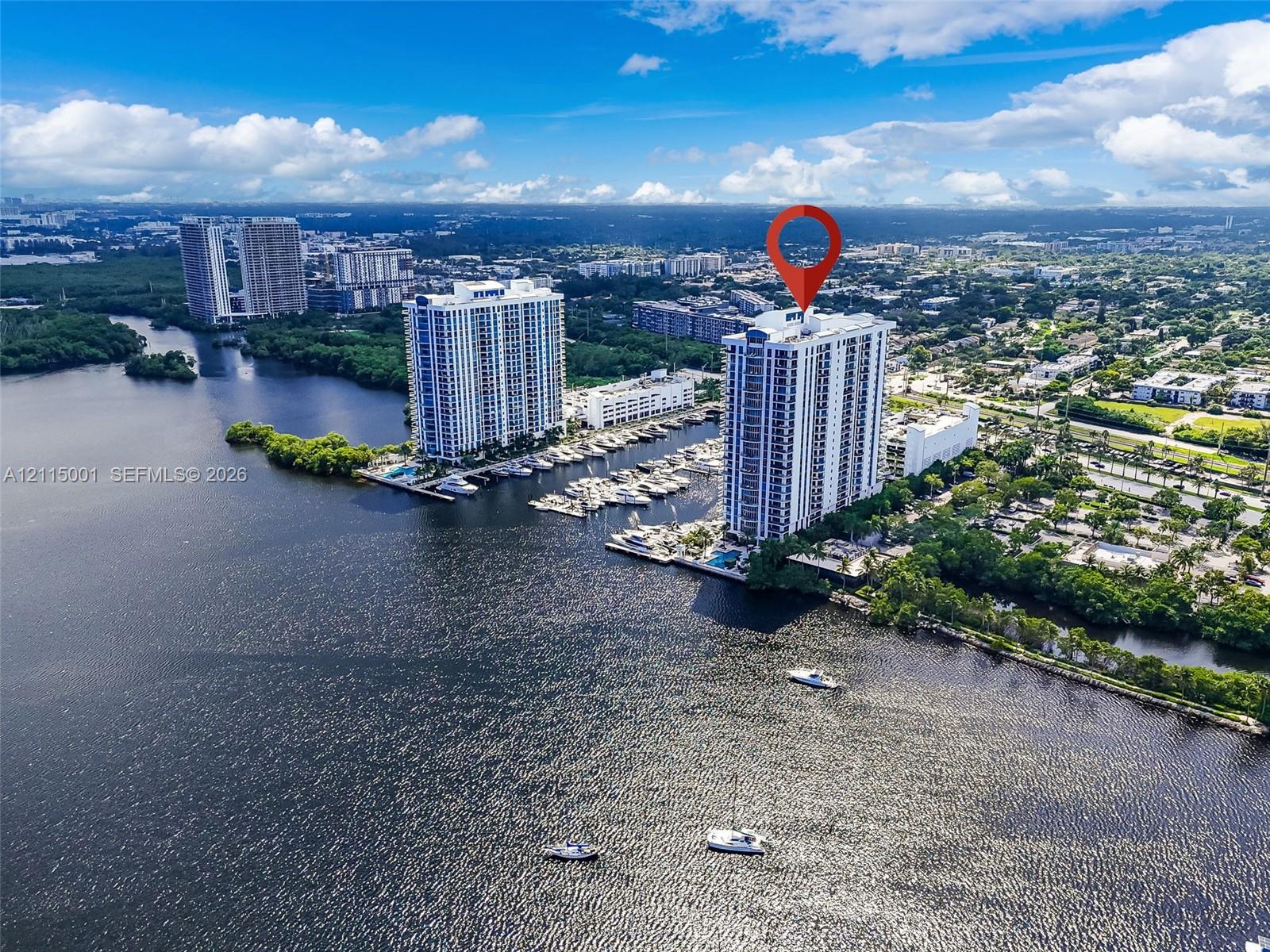 High-rise residential tower situated on a waterfront parcel featuring deep-water boat slips and direct canal access