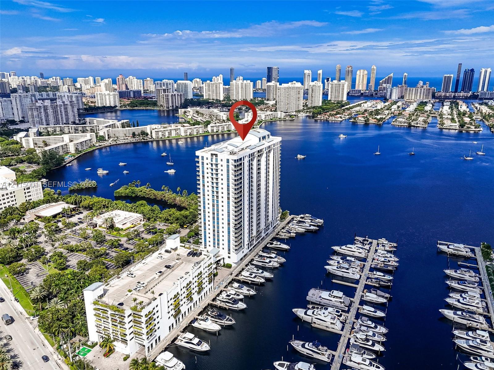 High-rise residential tower featuring a waterfront position, integrated marina docking, and expansive coastal water surroundings
