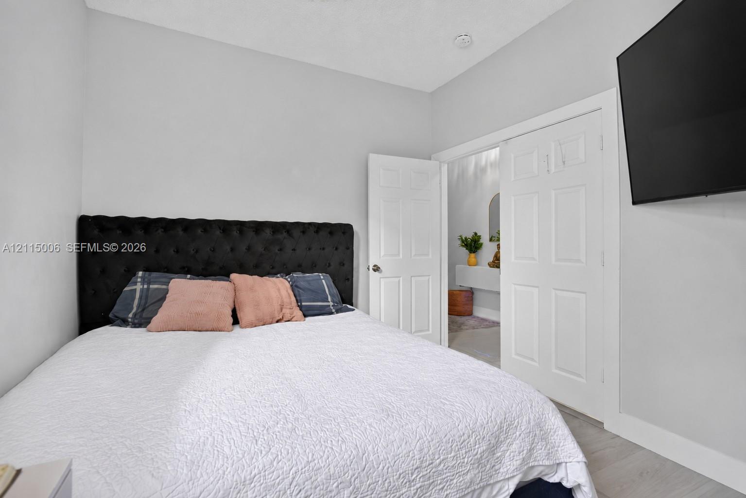 Neutral wall tones, wood-finish flooring, and six-panel interior doors