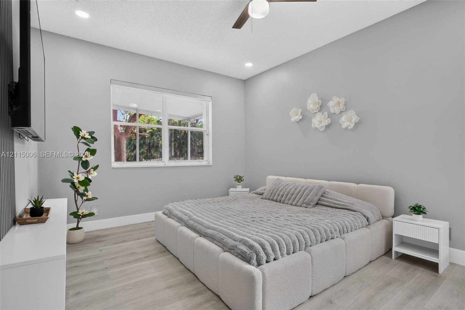 Bedroom featuring light-toned wood-finish flooring, recessed lighting, and a ceiling fan with integrated lighting