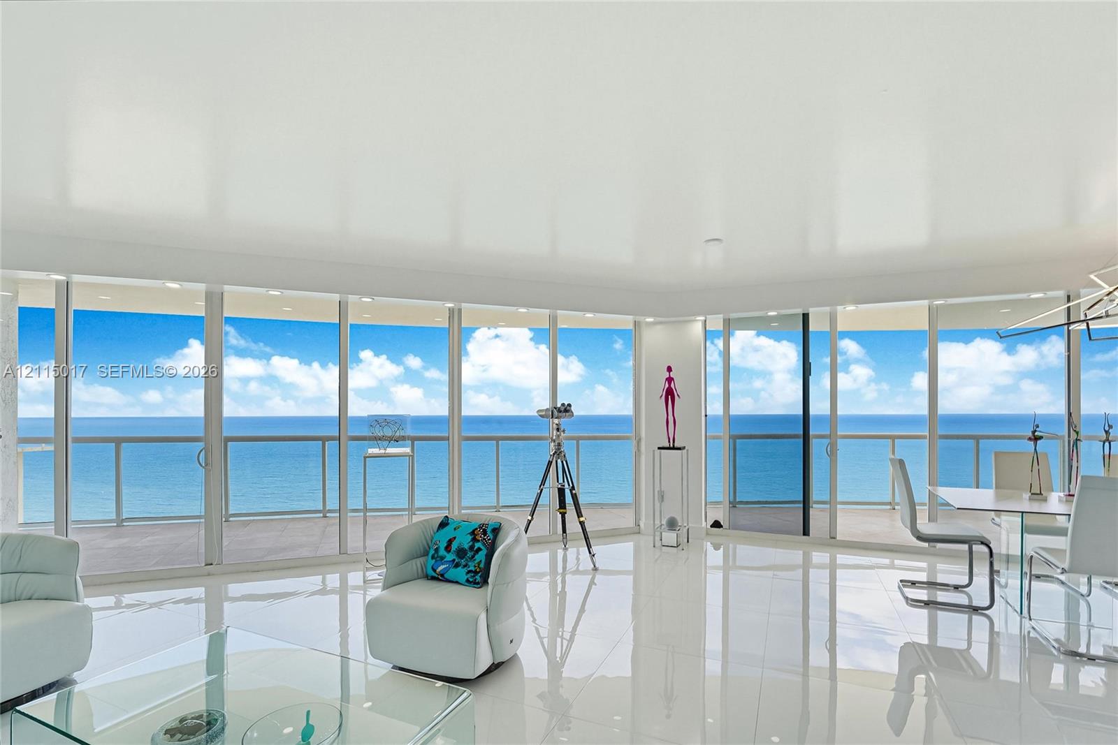 Floor-to-ceiling glass walls, wrap-around balcony with metal railing, high-gloss tile flooring, and recessed ceiling lighting