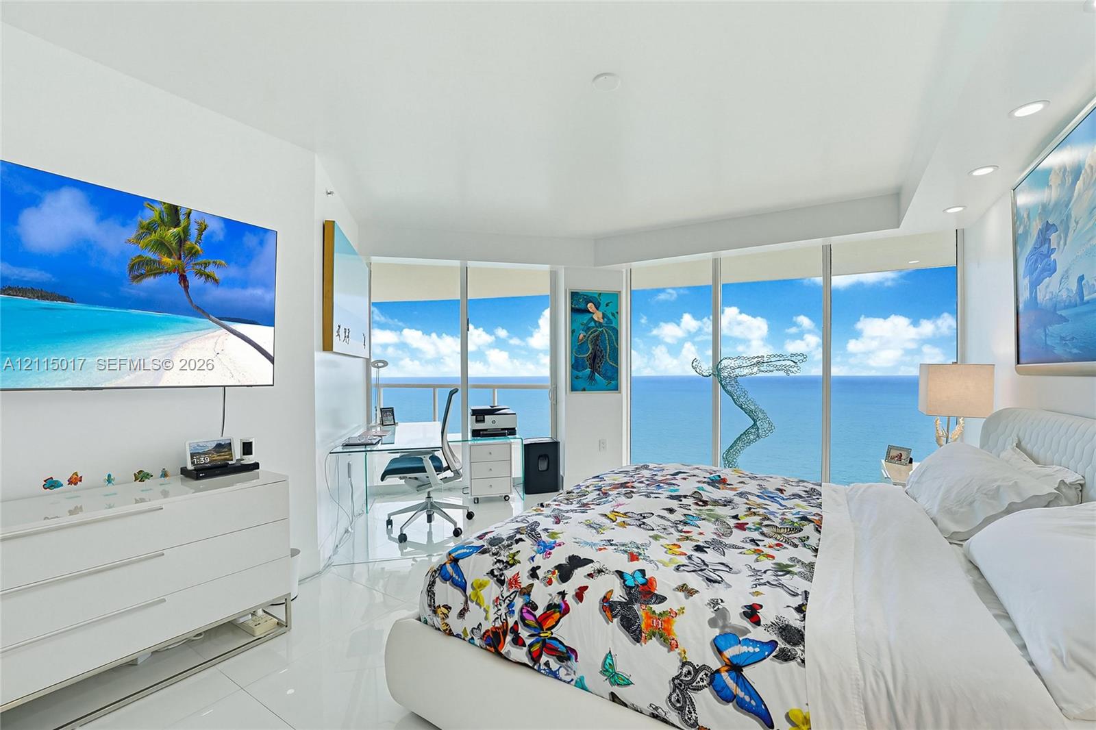 Floor-to-ceiling glass walls, polished tile flooring, recessed ceiling lighting, and private balcony access