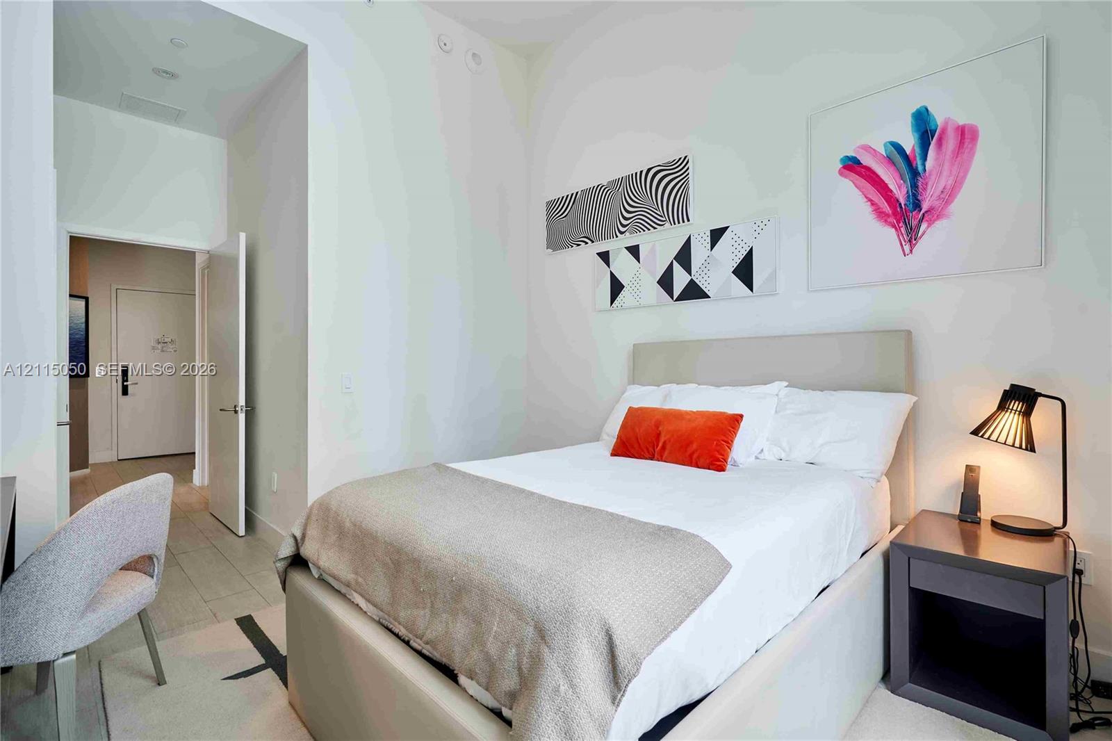 High ceilings, neutral wall palette, and recessed lighting