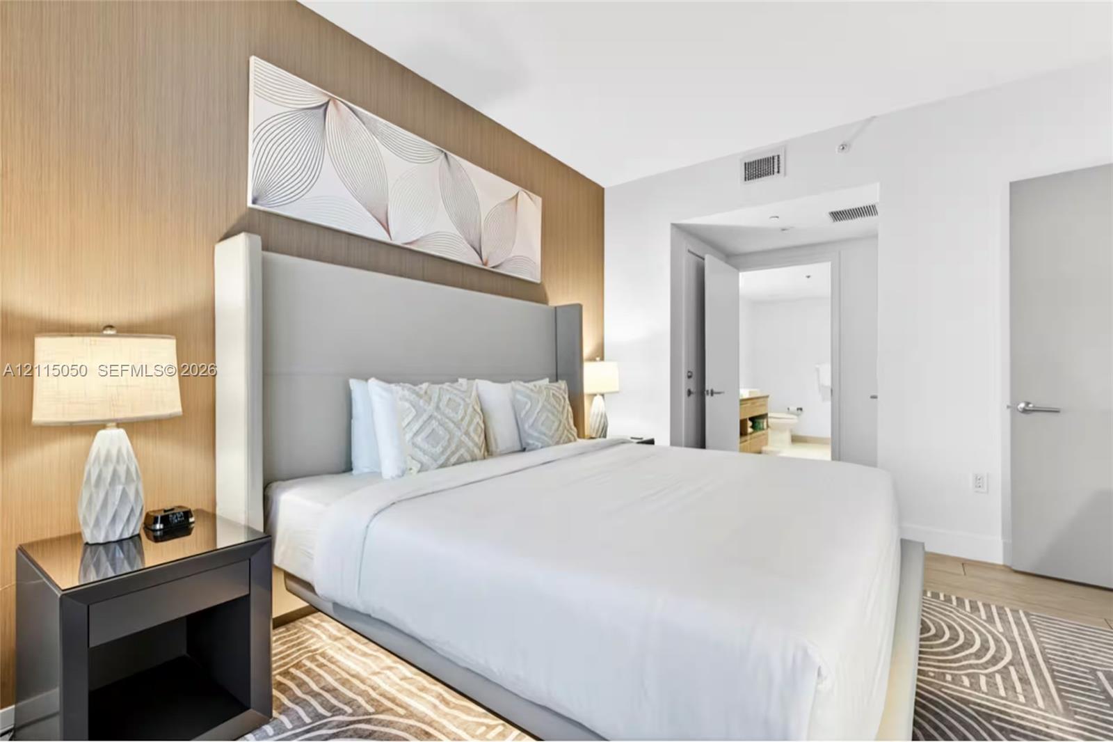Wood-finish accent wall, neutral interior palette, and smooth-finish interior doors