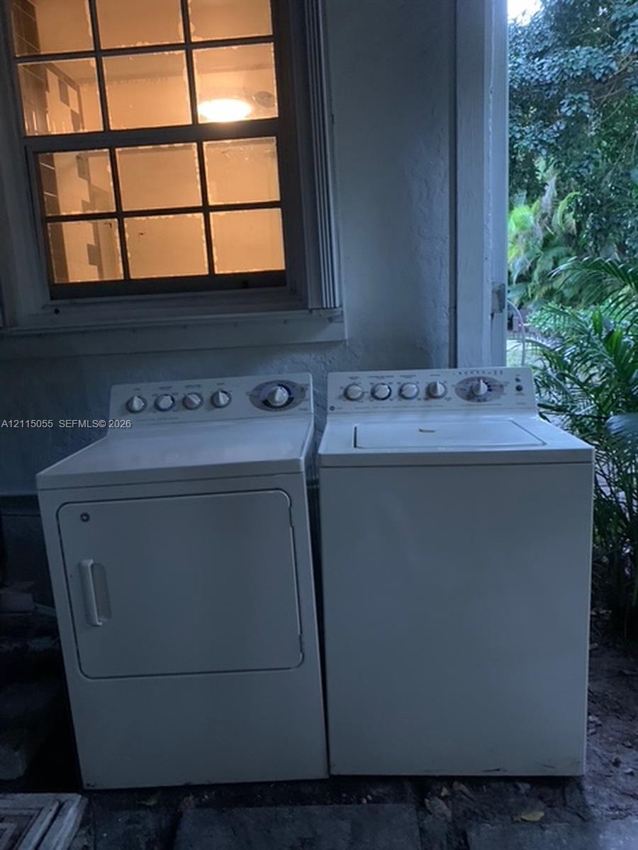Multi-pane window with white trim, top-load clothes washer, and front-load clothes dryer