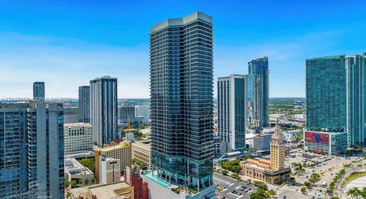High-rise residential tower featuring a glass facade, private balconies, and an elevated outdoor swimming pool High-rise residential tower featuring a glass facade, private balconies, and an elevated outdoor swimming pool
