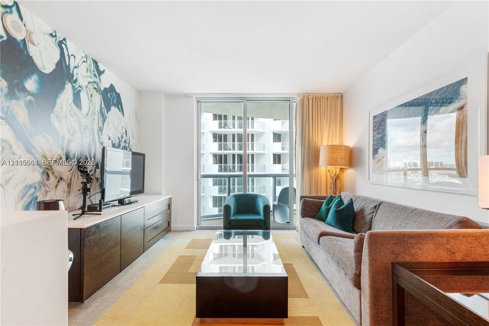 Full-height glass sliding doors, custom wall mural, built-in cabinetry, and neutral wall-to-wall carpeting