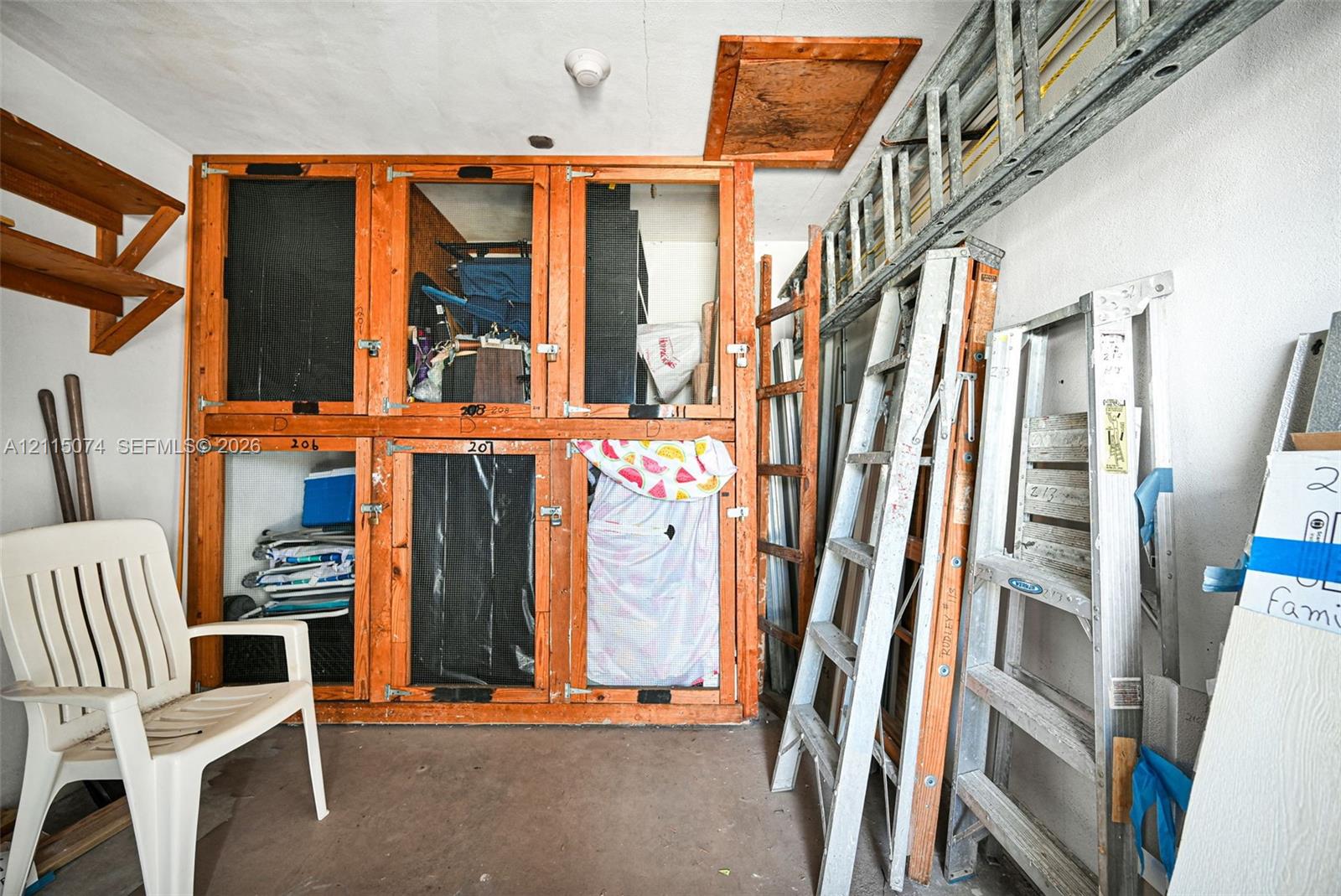 Custom-built wooden storage compartments featuring integrated latches and upper-level attic access panel