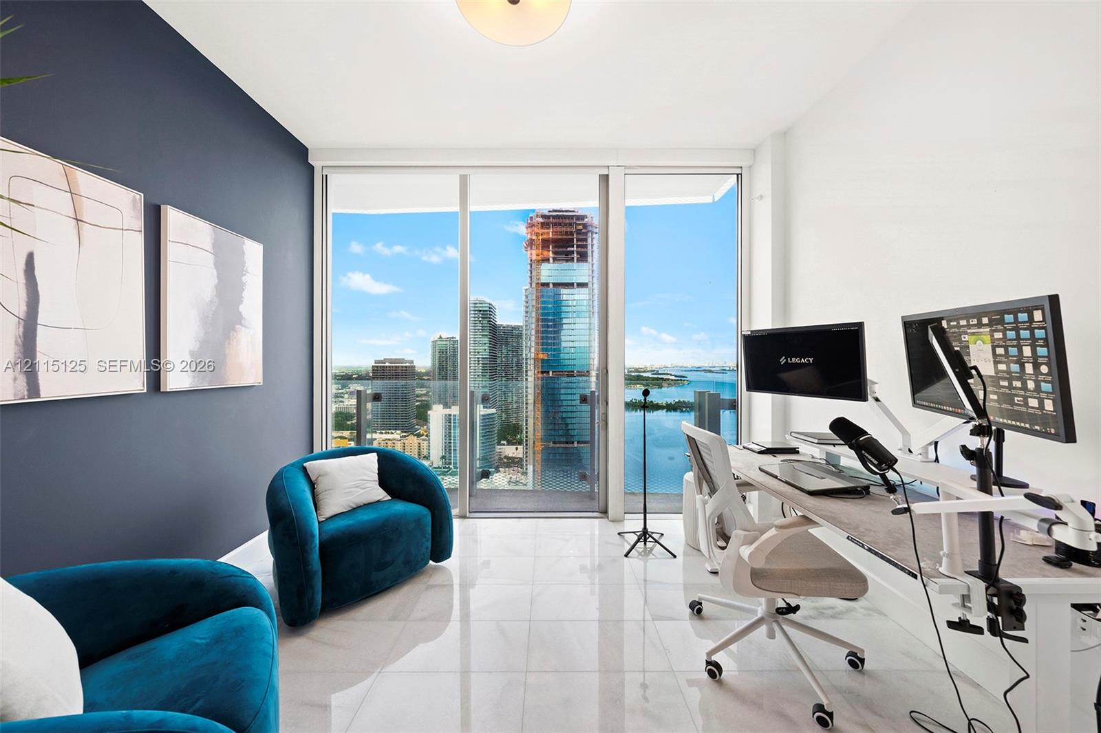 Floor-to-ceiling glass sliding doors, polished tile flooring, accent wall, and built-in flush-mount ceiling lighting