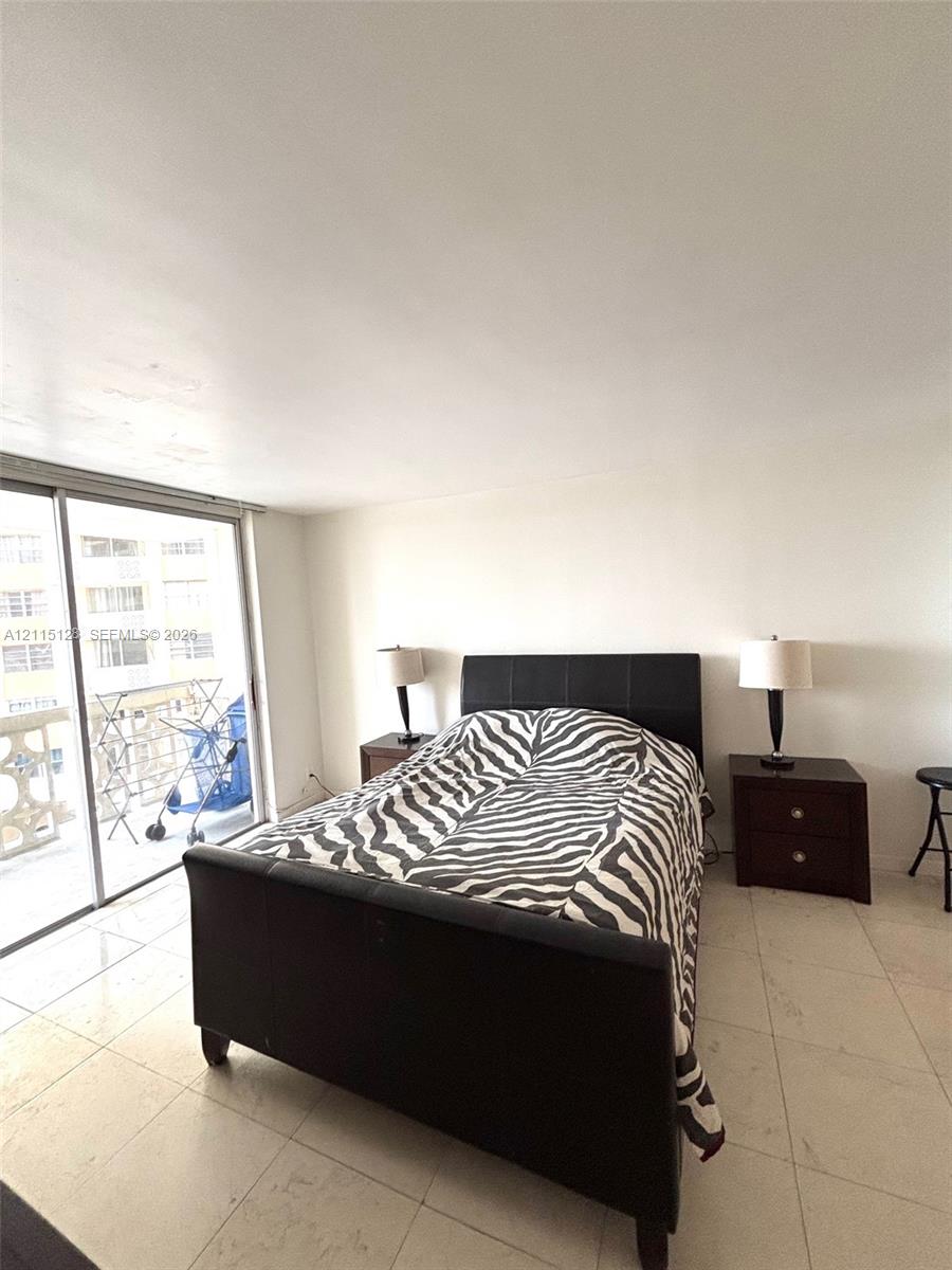 Large-format tile flooring and full-height sliding glass door