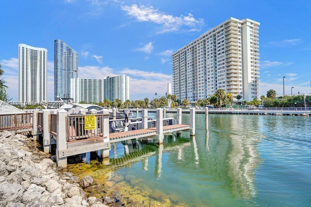 Waterfront deep-water boat slip featuring composite decking, vertical pilings, and a concrete-reinforced shoreline Waterfront deep-water boat slip featuring composite decking, vertical pilings, and a concrete-reinforced shoreline
