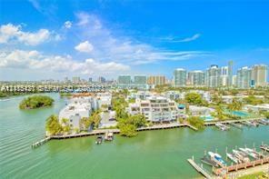 Waterfront property featuring private boat slips, multi-level residential structures, and mature coastal landscaping