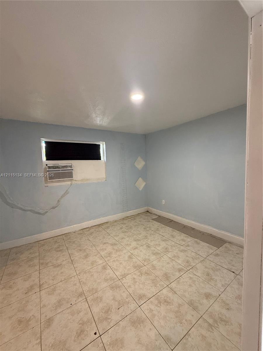 Interior room featuring neutral-toned tile flooring and a recessed lighting fixture