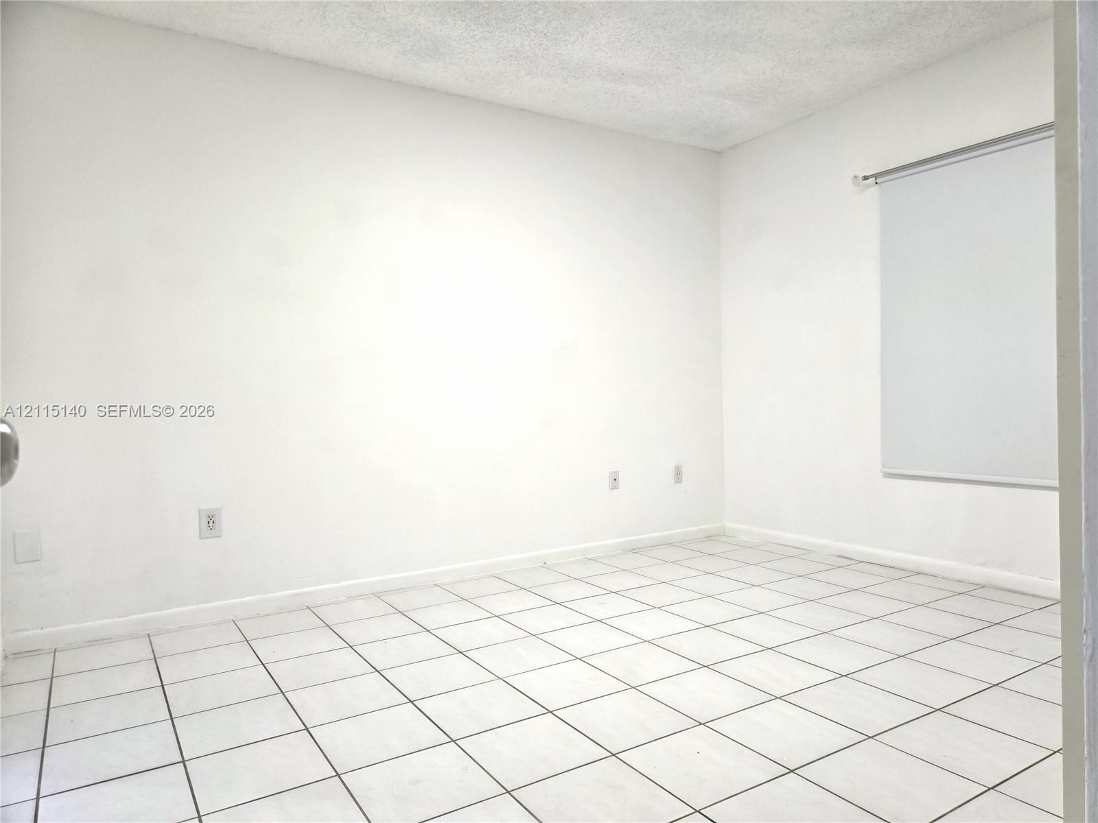 Interior room featuring white tile flooring and neutral walls