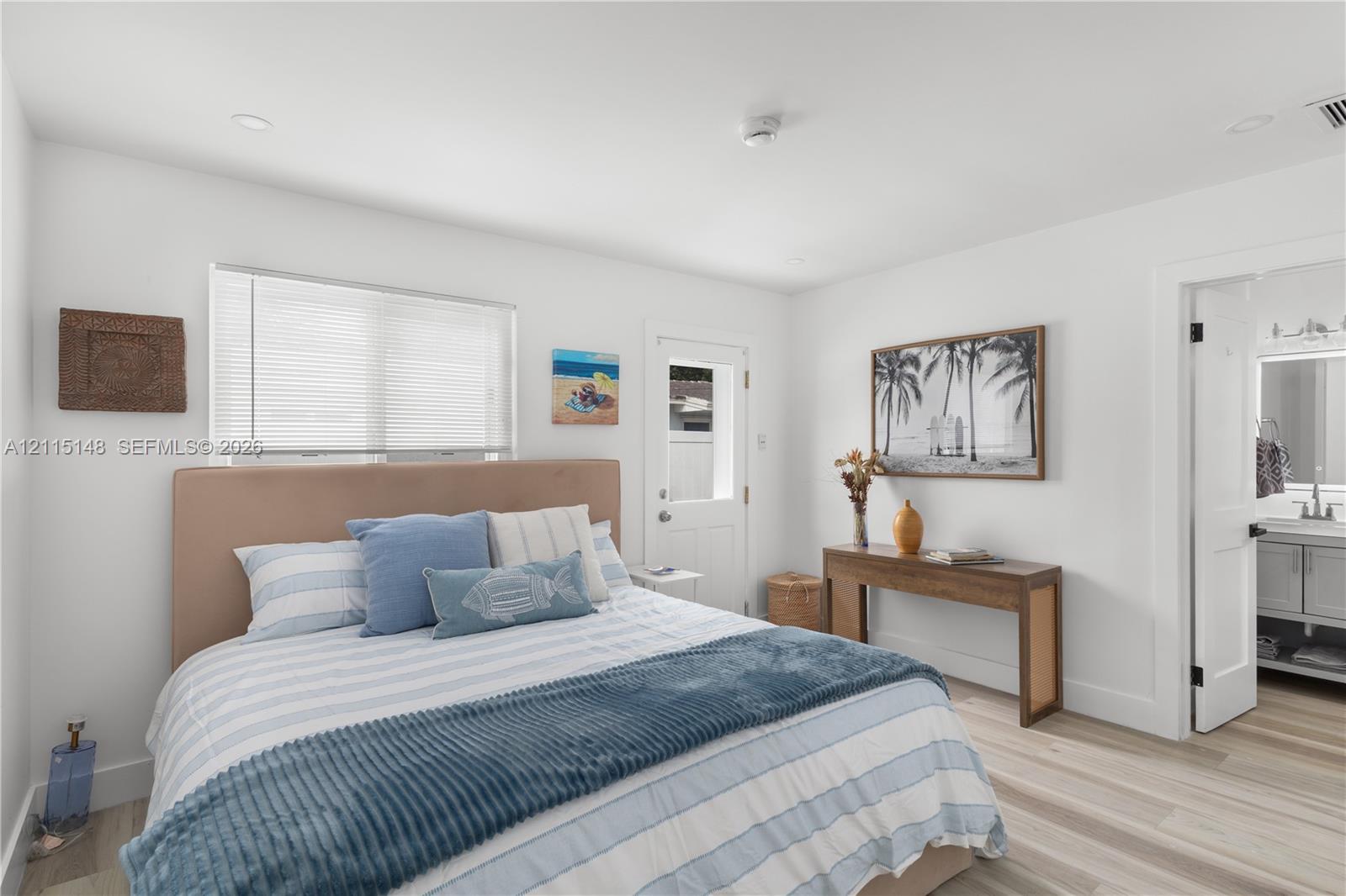 Bright interior featuring wood-finish flooring, recessed lighting, and a multi-pane glass-inset exterior door