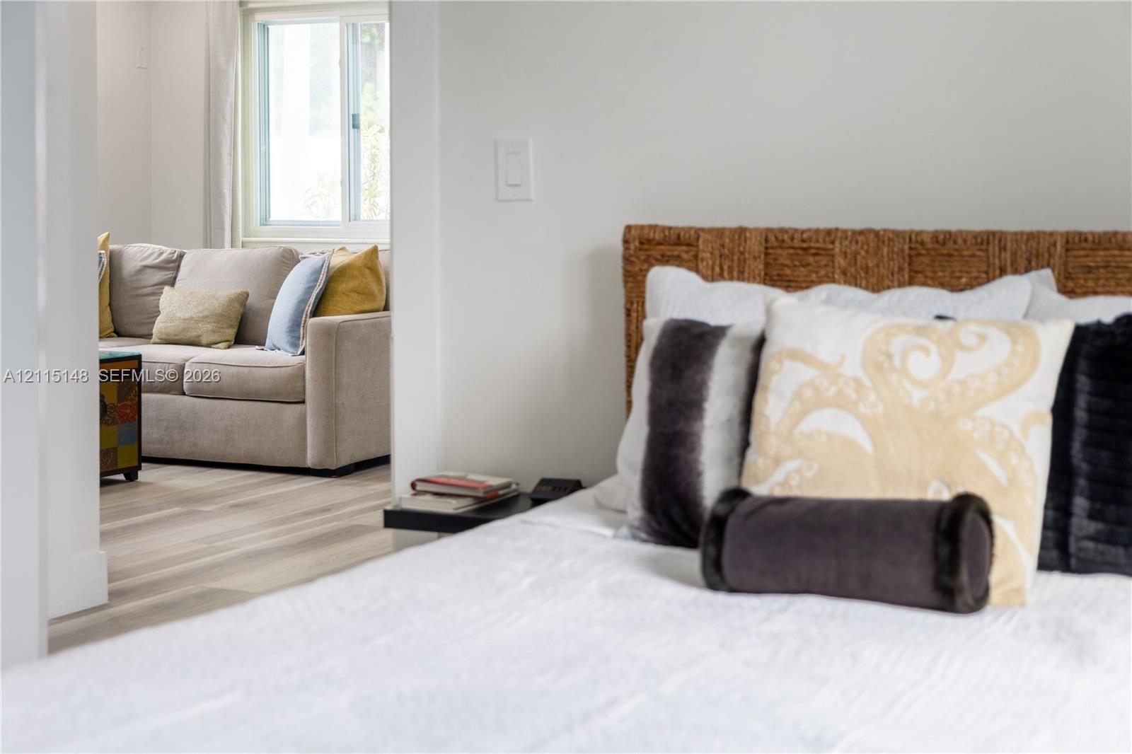 Neutral wall tones, light-finish wood flooring, and a sliding window