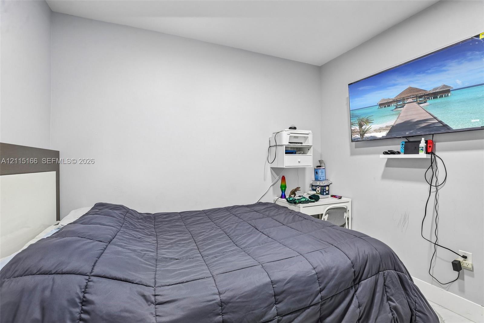 Neutral wall tones and a wall-mounted display shelf