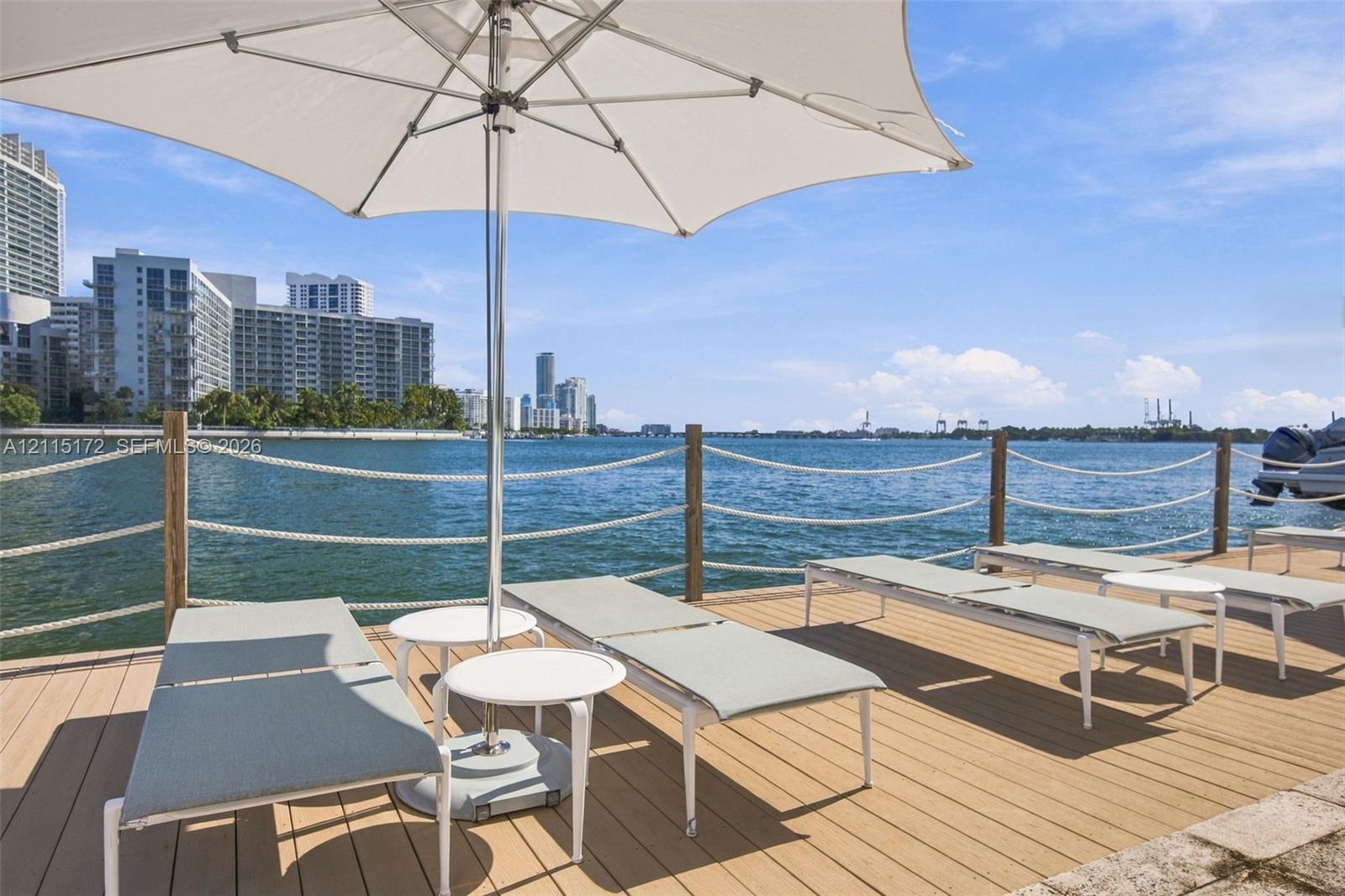 Waterfront wood-finish deck featuring a rope-rail perimeter