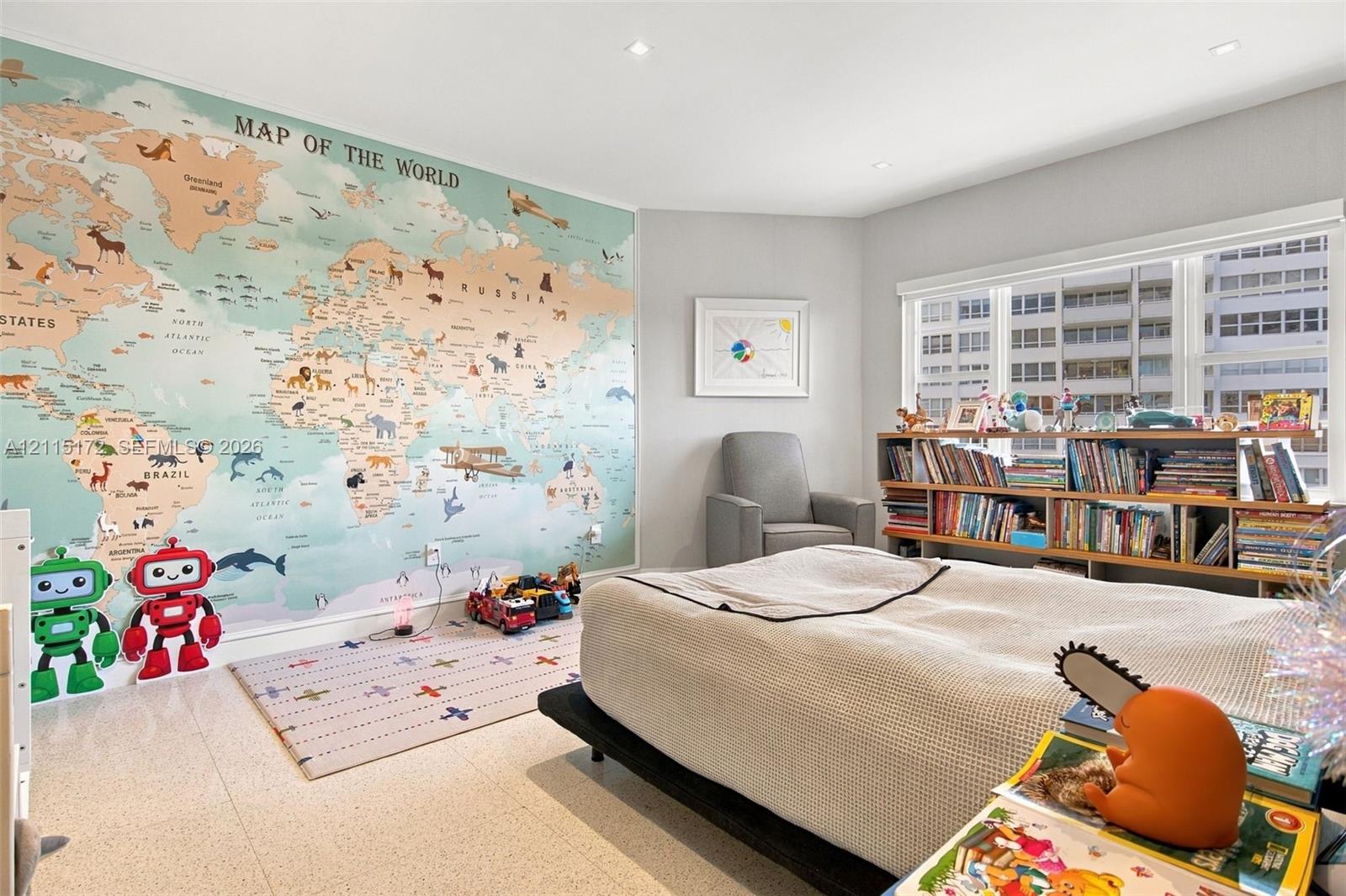 Room featuring a large-scale map wall mural, recessed ceiling lighting, and large windows with integrated blinds, finished with light-toned stone-style flooring