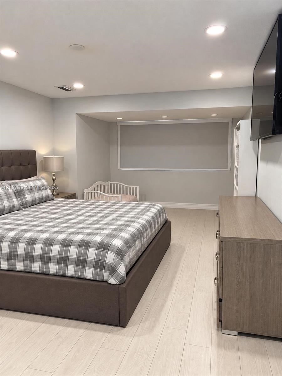 Neutral color palette featuring light-toned wood-finish flooring, recessed lighting, and a recessed window nook Neutral color palette featuring light-toned wood-finish flooring, recessed lighting, and a recessed window nook