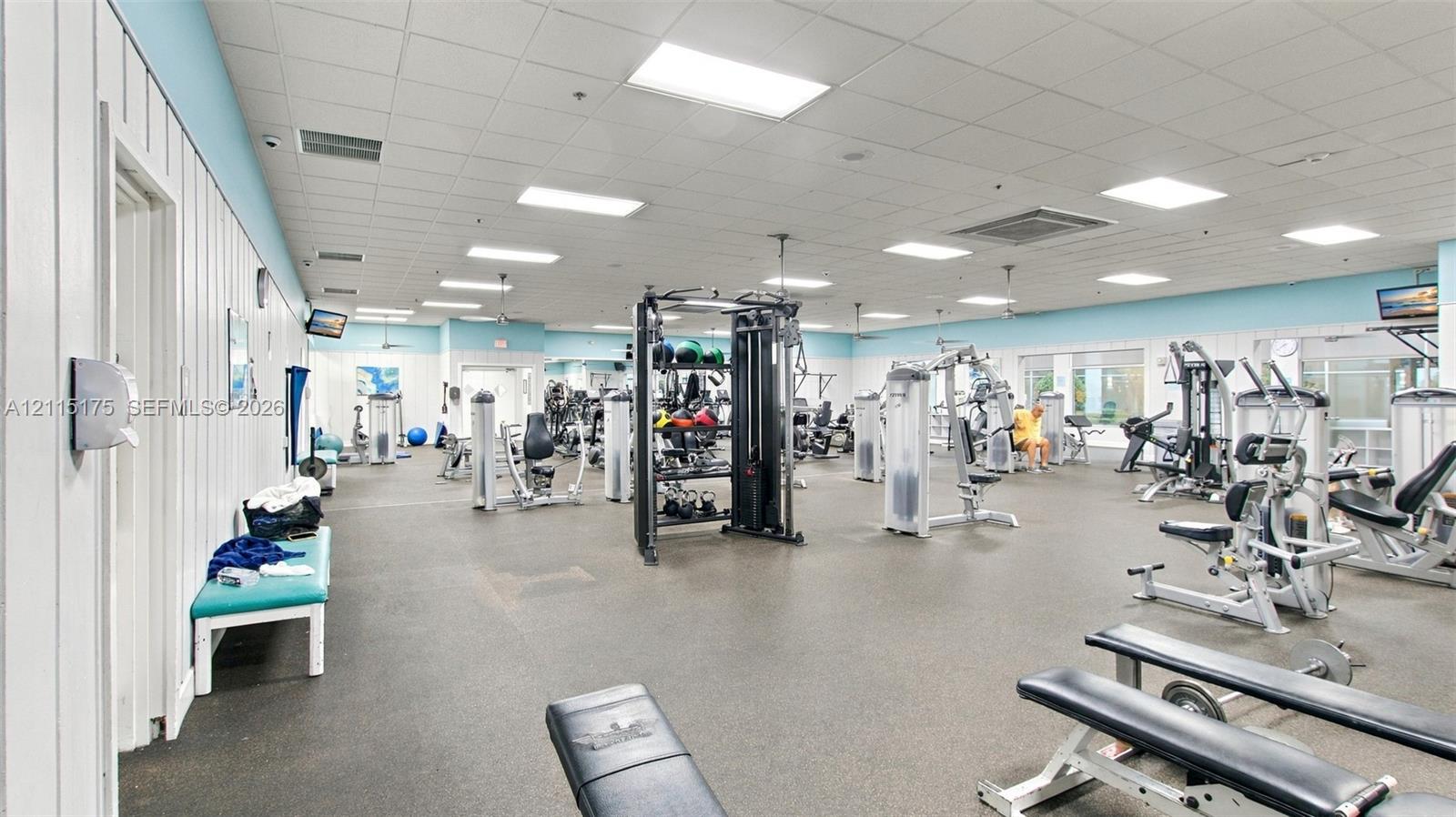 Fitness center featuring a drop ceiling with recessed lighting