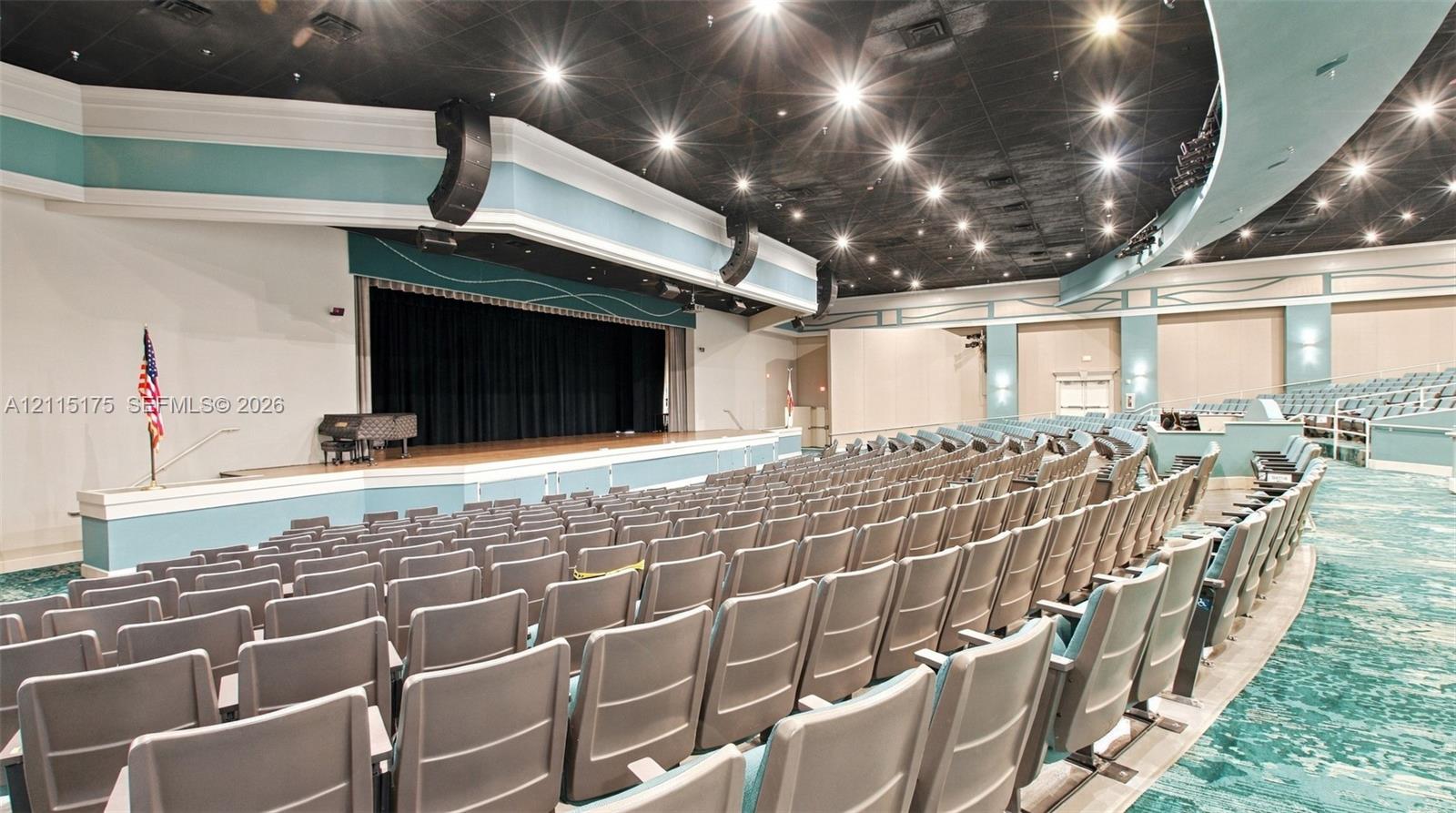 Large theater with stadium fixed tiered seating for live shows and movies