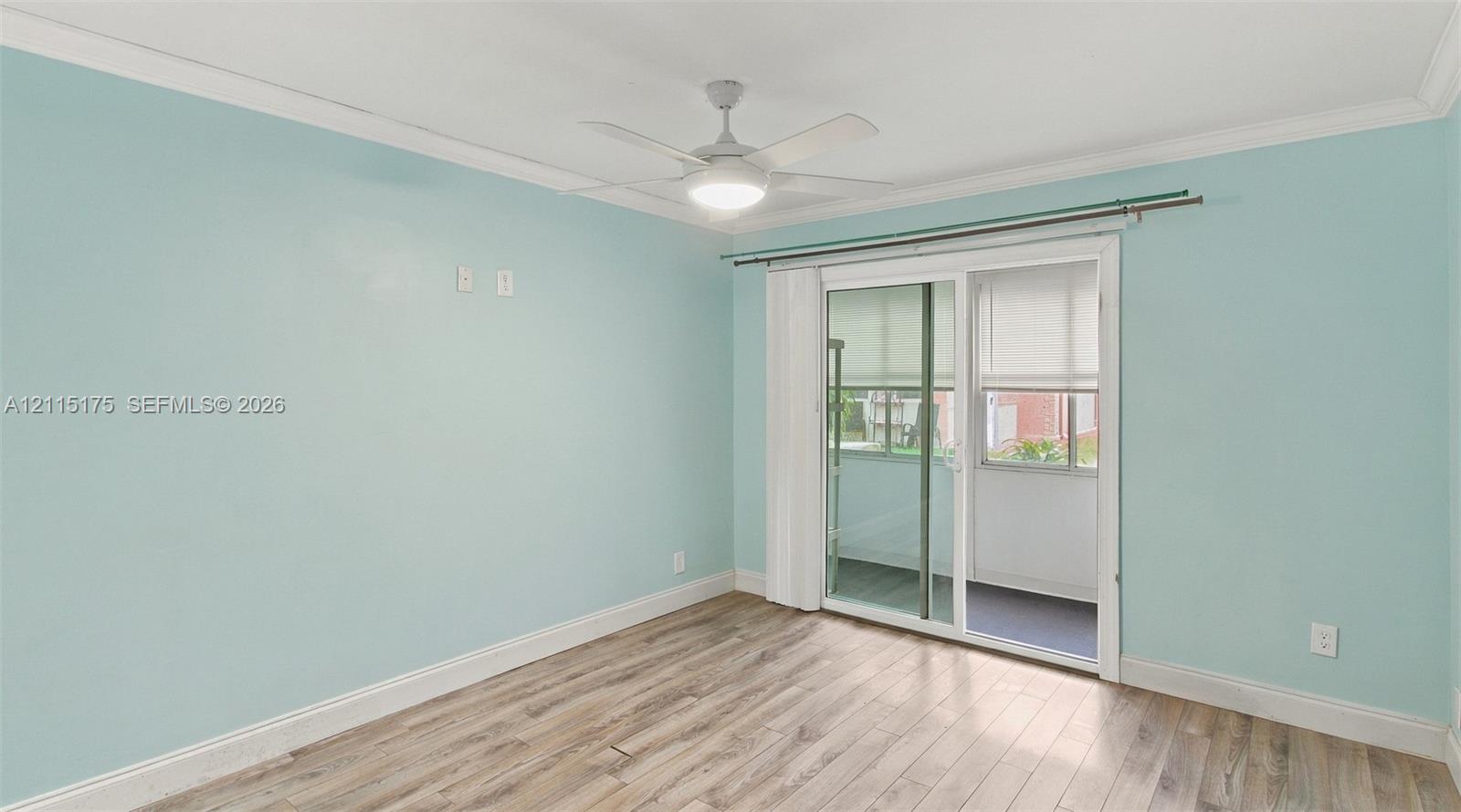 Primary bedroom with its own glass sliding doors leading to lanai.
